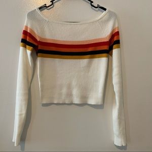 White sweater with stripes across chest